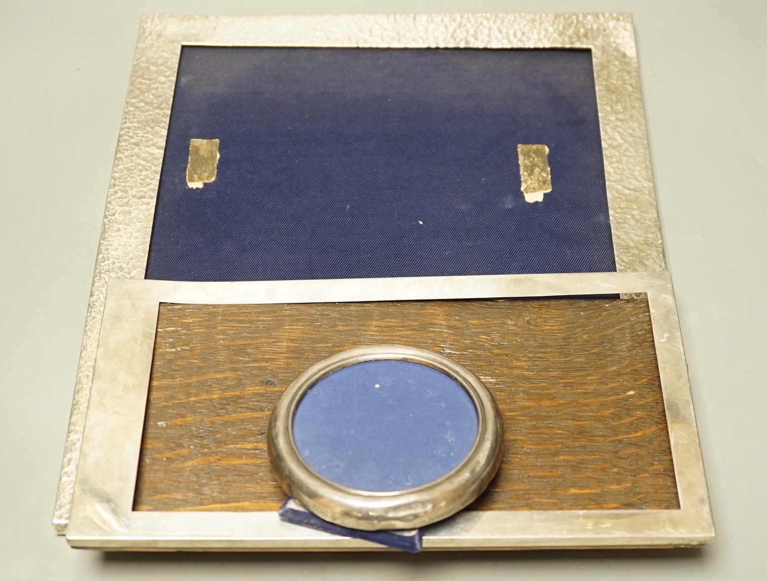 A George V large planished silver mounted rectangular photograph frame, E. Mander & Son, Birmingham, 1912, 33cm and two other silver mounted photograph frames.